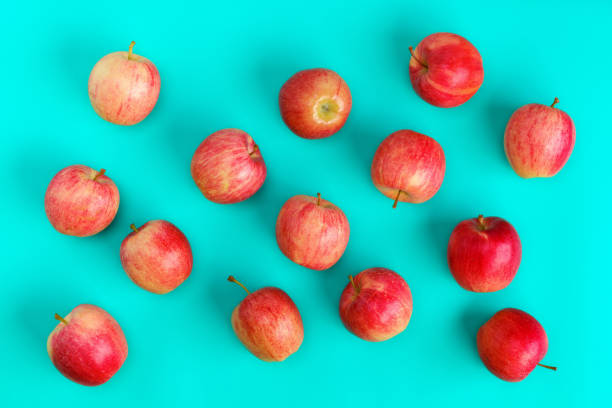 istock Fruit pattern of red apple on blue background. Flat lay, top view. Pop art design, creative summer concept. Food background. 1411675410