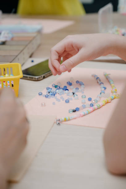 istock Jewelry making and beading process.Fashion, creativity and handmade concept 1411677739