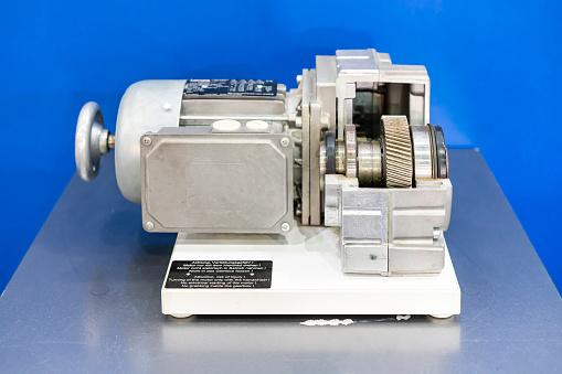 cross section show metal helical gear or cogs gear bearing housing shaft and detail inside of transmissions gearbox for industrial assembly with electric induction motor