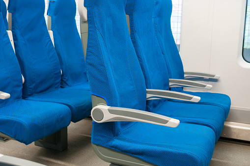 Interior of railway wagon with row comfortable blue seats