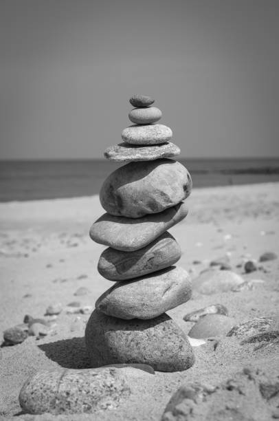Stones stack balance tranquil concept on a coast line. Black and white image