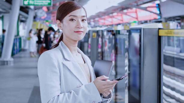 istock Businesswoman waiting for a sky train 1411680863
