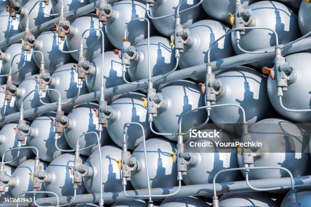 A Lot Of Bottles Filled With Gas Or Gasoline Are Stacked In Piles Stock Photo - Download Image Now