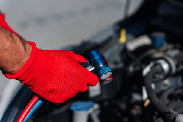 istock Car air condition ac repair service. Refill automobile ac compressor and checking auto conditioning system. Auto car conditioner diagnostic. 1411684304