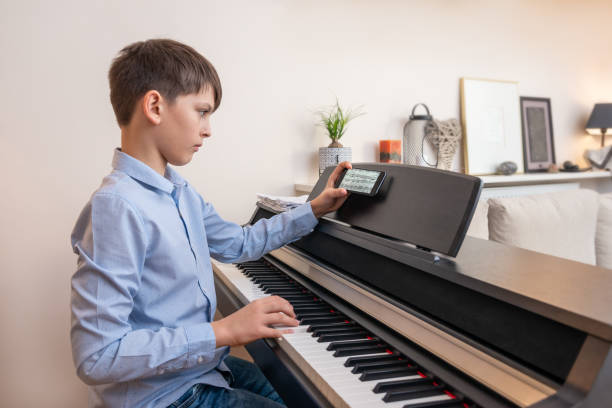 istock The boy plays the piano. 1411688130