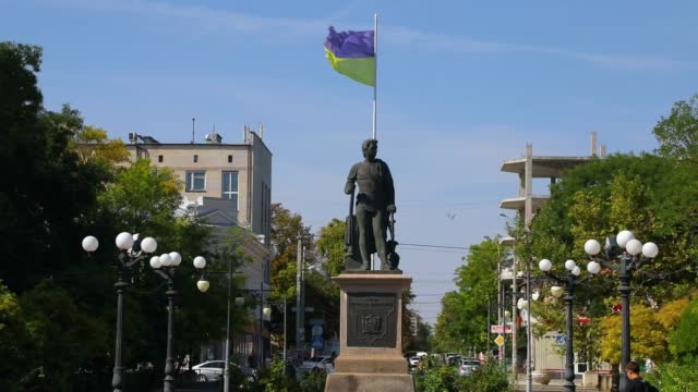 Memorial statue, monument with Ukrainian National flag in Kherson, Ukraine.