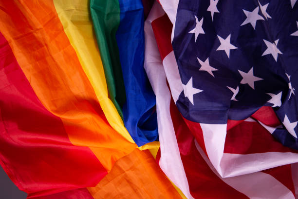 istock Equality. American and gay flag side by side. 1411694422