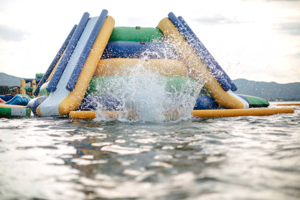 Kid having fun in Water Park Boy enjoying in Water park jumping in water top of water slide photos stock pictures, royalty-free photos & images