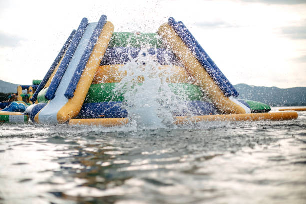 Kid having fun in Water Park Boy enjoying in Water park jumping in water top of water slide photos stock pictures, royalty-free photos & images