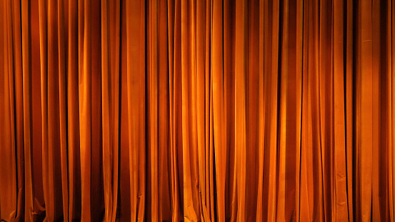 The yellow curtain. Theatrical scenes with light from the spotlights in the closed position.