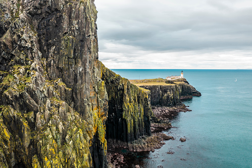 Coastline in Scottish Highlands with a steep Cliff and Neist Point Lighthouse