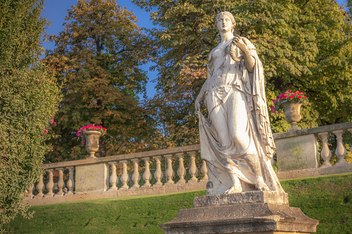 Beatutiful Luxembourg gardens with one of the 20 Queens of Jardin du Luxembourg statue at springtime, Paris, France\n\nThe twenty sculptures are monuments to the women — queens, saints, and celebrities — who through their lives and works left their mark on the country. The sculptures were commissioned by Louis-Philippe, king of France from 1830 to 1848. \nThe Ministry of Beaux-Arts set upon hiring the best sculptors of the time to complete the massive project between 1843 and 1846.