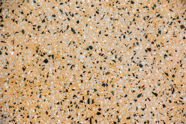 istock The texture of the stone wall. Abstract background with small multicolored stone particles. 1411704053