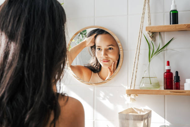 istock Beautiful hispanic woman looking in the mirror 1411709785