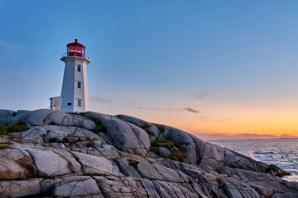 istock Peggy's Cove Lighthouse at Sunset 1411710370