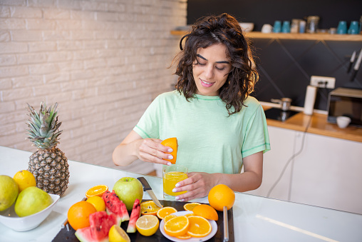 Woman with healthy food on the kitchen