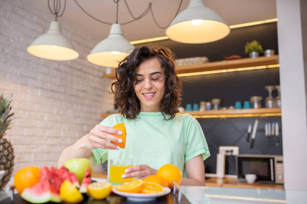 istock A young smiling woman having healthy breakfast 1411711255