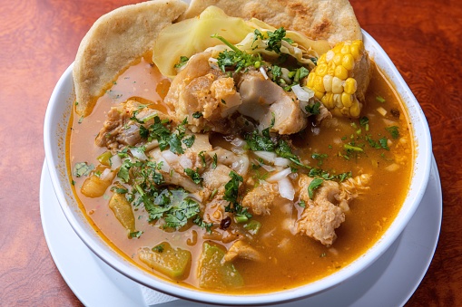 Sopa de pata is a hearty Salvadoran soup made from cow's feet, tripe, yuca, cabbage leaves, chayotes, sweet corn, plantains, and green beans. It may be seasoned with Mexican coriander leaves and flavored to taste with lemon or chile powder.