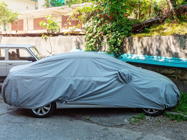 istock A car covered with a protective cover is parked in the yard 1411711505