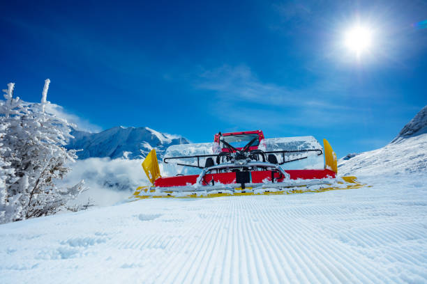 lines in the snow with sun and shadows and blue sky, prepared slope for wintersport and ski