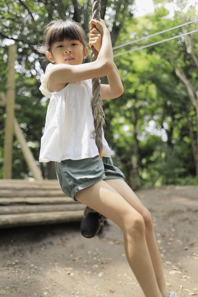istock Japanese student girl playing with flying fox (7 years old) 1411719663