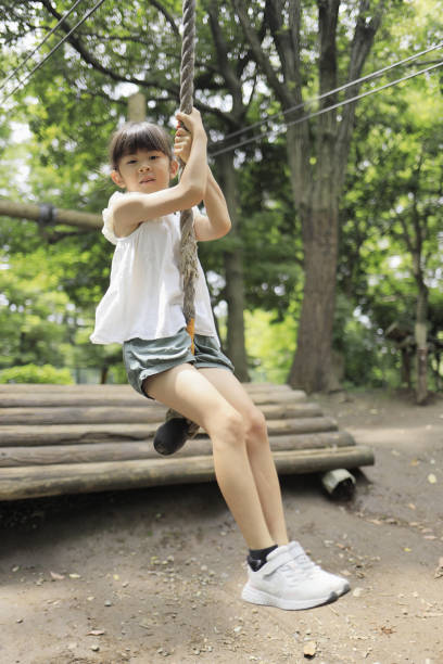 istock Japanese student girl playing with flying fox (7 years old) 1411719681