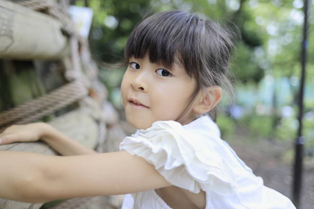 istock Japanese student girl playing at outdoor obstacle course (7 years old) 1411719694
