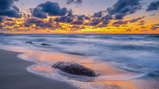 istock colorful sunset on the rocky seashore 1411727484