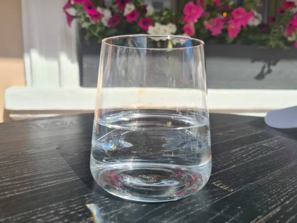 istock Glass of clean cold water on table in a cafe 1411727564