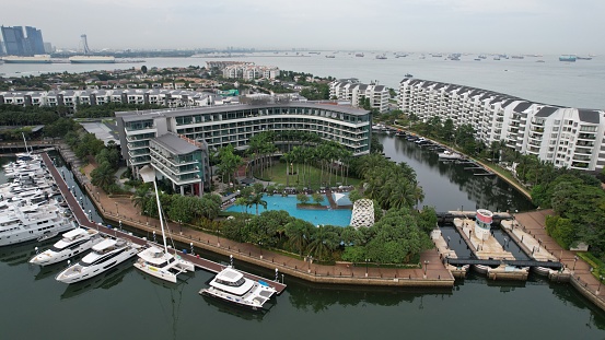 Aerial view of luxury yachts docked in the Sentosa Island, Cove area, in Singapore. Taken during day time. The area was around some hotels and condominiums