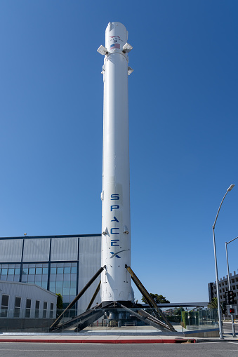 Hawthorne, California, USA - July 5, 2022: SpaceX historic first Falcon 9 rocket booster that returned back on Earth erected in front of SpaceX’s headquarters in Hawthorne, California, USA.