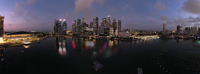 Marina Bay, Singapore - July 13, 2022: A group of buildings opposite the MBS hotel taken at night, aerial, at the downtown area