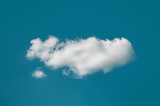 Single cloud in deep blue sky looks like whale in ocean, dream like cloudscape, daydreaming concept