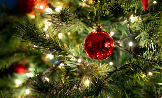 Close-up on the Christmas ornaments hanging on the tree - holidays concepts