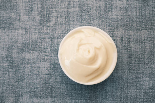 istock close up of Mayonnaise in container on table . 1411741662