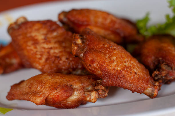 istock Fried chicken wing in white plate in the kitchen. 1411748061