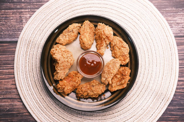 istock Crispy fried chicken wings on a plate top view . 1411748243