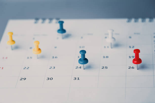istock Embroidered red pins on a calendar event Planner calendar,clock to set timetable organize schedule,planning for business meeting or travel planning concept. 1411749921