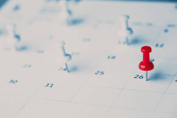 istock Embroidered red pins on a calendar event Planner calendar,clock to set timetable organize schedule,planning for business meeting or travel planning concept. 1411749923
