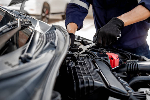 istock Car care maintenance and servicing, Close-up hand technician auto mechanic using the wrench to repairing change spare part car engine problem and insurance service support. 1411749954