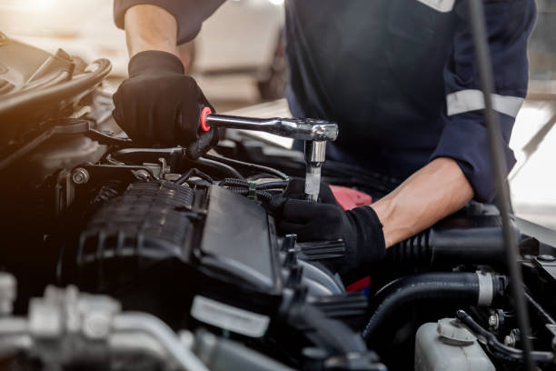 istock Car care maintenance and servicing, Close-up hand technician auto mechanic using the wrench to repairing change spare part car engine problem and insurance service support. 1411749955