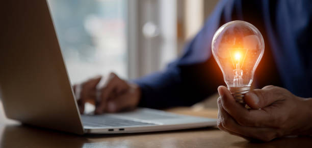 istock Close up hand choose light bulb or lamp with bright for human resources or leadership and creativity thinking idea motivation or vision and knowledge learning. 1411749997