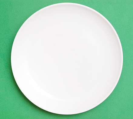 White plate on green background