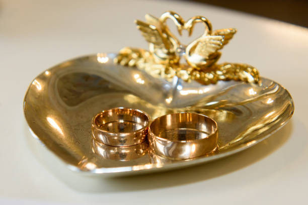 istock Gold wedding rings on a gilded heart tray. 1411758928
