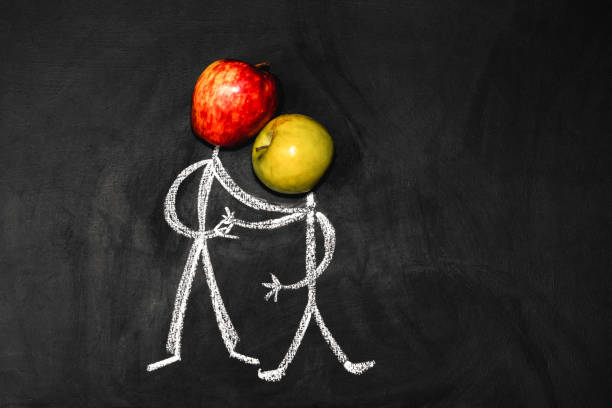 Two friends shake hands. Man with an apple instead of a head on a black background