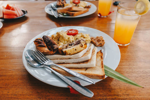 istock Breakfast set with orange juice on the table. 1411759625