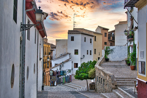 Cobbled and steep alleyways in the old quarter of Granada at sunset, Spain