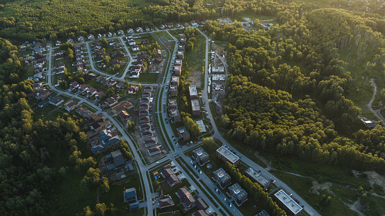 Small modern village in summer at sunset. Aerial view
