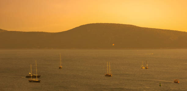 Boats and sunset on Bodrum shores. Aegean coast in summer. Turkey's famous tourist holiday destination