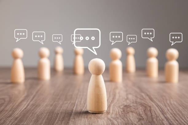 istock Wooden figurine with speech bubble. Mingle, discussion, chatting concept 1411762899